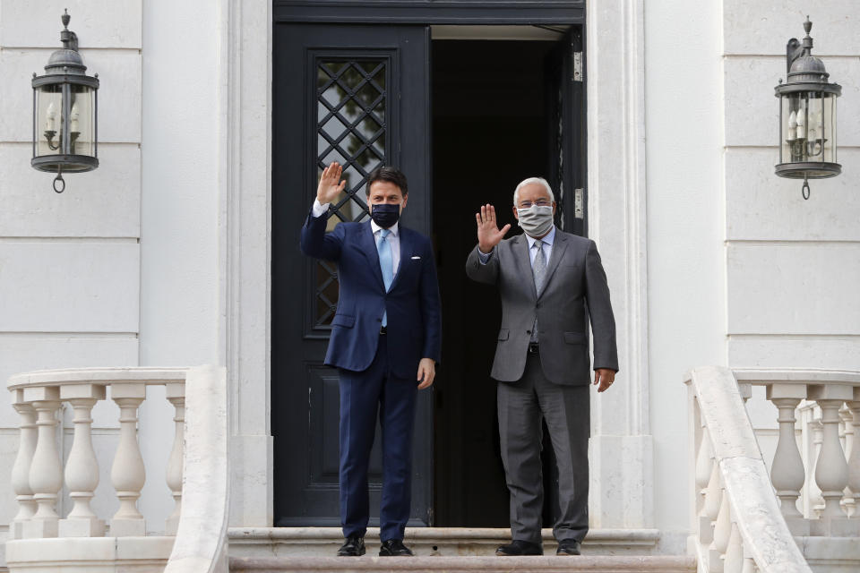 Italy's Prime Minister Giuseppe Conte, left and Portugal's Prime Minister Antonio Costa pose for a photo, before their meeting at the Sao Bento palace in Lisbon, Tuesday, July 7, 2020. Southern European countries are mounting a show of strength as negotiations over how much money they get from the EU, and in what form, comes to a crunch. (AP Photo/Armando Franca)