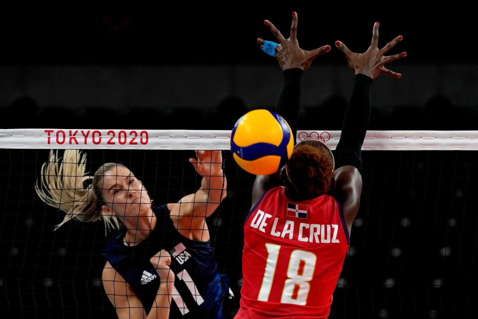 The United States' Andrea Drews (11) spikes the ball past the Dominican Republic's Bethania de la Cruz de Pena.