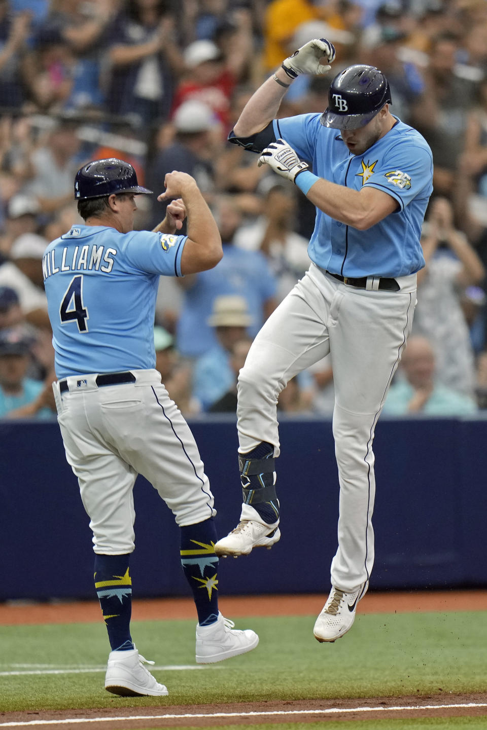 Tampa Bay Rays' Luke Raley celebrates with third base coach Brady Williams (4) after hitting a two-run home run off Chicago White Sox starting pitcher Lucas Giolito during the second inning of a baseball game Sunday, April 23, 2023, in St. Petersburg, Fla. (AP Photo/Chris O'Meara)