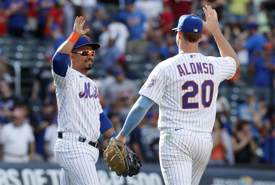 Eduardo Escobar (10) and Pete Alonso (20) of the New York Mets celebrate after defeating the Philadelphia Phillies on Sunday. (Photo by Jim McIsaac/Getty Images)