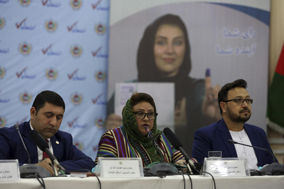 Hawa Alam Nuristani, chief of the Election Commission of Afghanistan, center, speaks during a press conference at the commission's office in Kabul, Afghanistan, Tuesday, Feb. 18, 2020. Afghanistan's independent election commission says President Ashraf Ghani has won a second term as president in a vote that took place on Sept. 28 last year. (AP Photo/Rahmat Gul)