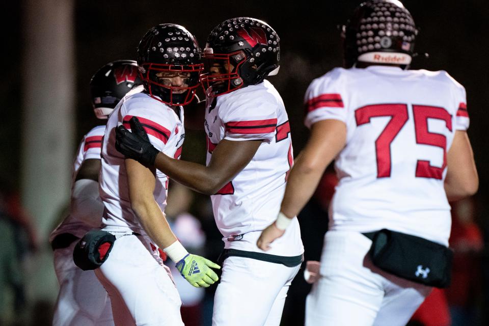 Lakota West quarterback Mitch Bolden (7) celebrates with offensive lineman Christian O’Neal (77) after scoring a touchdown in the OHSAA playoff regional final Friday.
