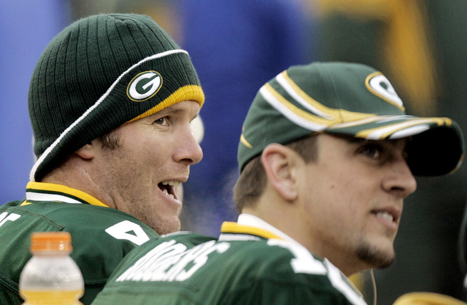 FILE - In this Jan. 1, 2006, file photo, Green Bay Packers quarterback Brett Favre, left, and back-up Aaron Rogers share time on the bench during their NFL football game against the Seattle Seahawks in Green Bay, Wis. Former quarterback Favre says Rodgers was surprised by Green Bay's decision to draft a quarterback in the first round. Favre said Wednesday, April 29, 2020, on 