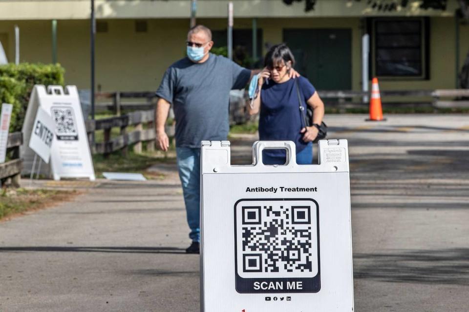 A couple walk out after visiting a monoclonal antibodies distribution site to treat COVID-19, at Tropical Park on Jan. 4.