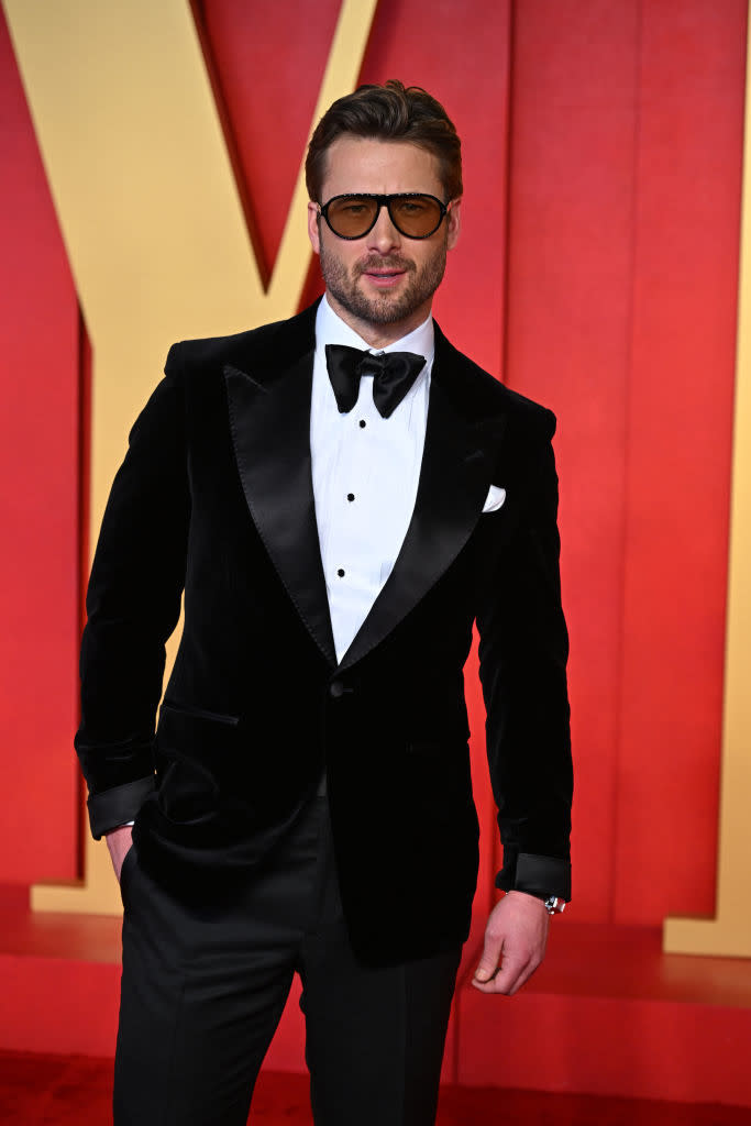 Man in black tuxedo with bow tie on red carpet