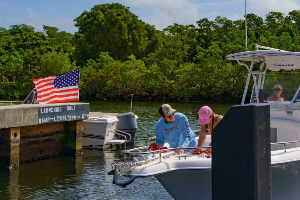 Lucas Bonell, left, and Samantha Windsor tie up the lines after pushing their boat off the dock during the extra day of lobster miniseason on Sunday, July 14, 2024 at Black Point Marina in Homestead, Fla.
