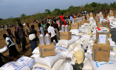 South Sudanese refugees displaced by fighting, receive food rations in Imvepi settlement in Arua district, northern Uganda, April 4, 2017. Picture taken April 4, 2017. REUTERS/James Akena