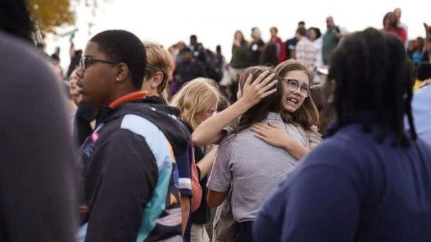 PHOTO: People gather outside after a shooting at Central Visual and Performing Arts high school in St. Louis, on Oct. 24, 2022. (Jordan Opp/St. Louis Post-Dispatch via AP)