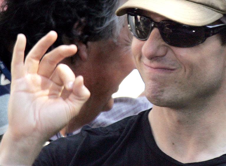 US actor Tom Cruise makes an OK sign to his fans as he leaves the set of the movie "Mission Impossible III" in central Rome, July 14, 2005