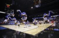 Kentucky cheerleaders flip before an NCAA Midwest Regional semifinal college basketball tournament game against the Louisville Friday, March 28, 2014, in Indianapolis. (AP Photo/David J. Phillip)