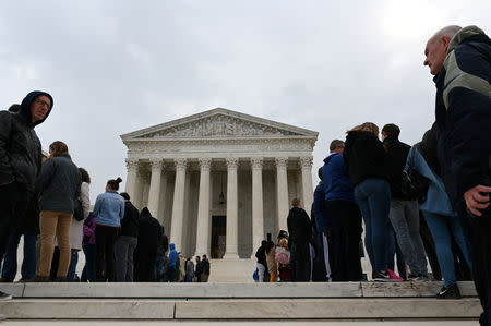 FILE PHOTO: People wait in line outside the U.S. Supreme Court to hear the orders being issued, in Washington, U.S. March 18, 2019. REUTERS/Erin Scott/File Photo