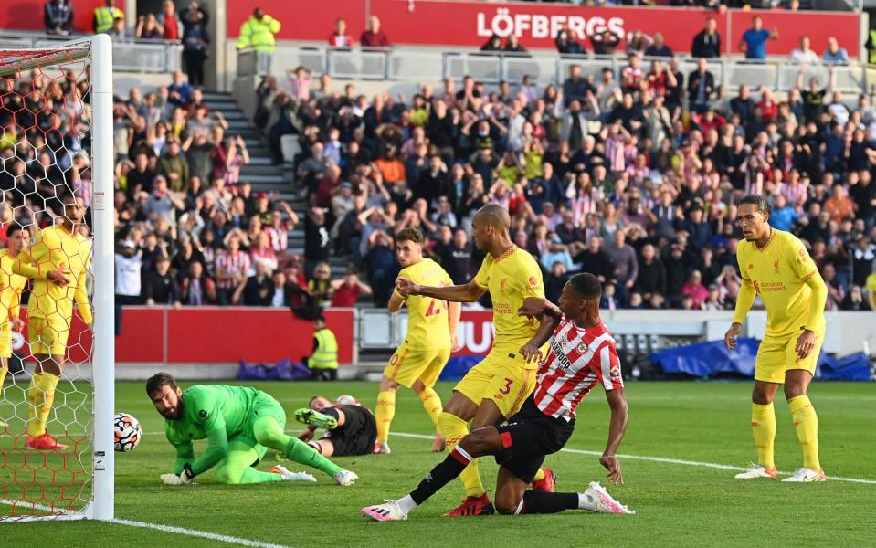 Brentford's English-born Jamaican defender Ethan Pinnock scores the opening goal during the English Premier League football match between Brentford and Liverpool. - GLYN KIRK/AFP via Getty Images