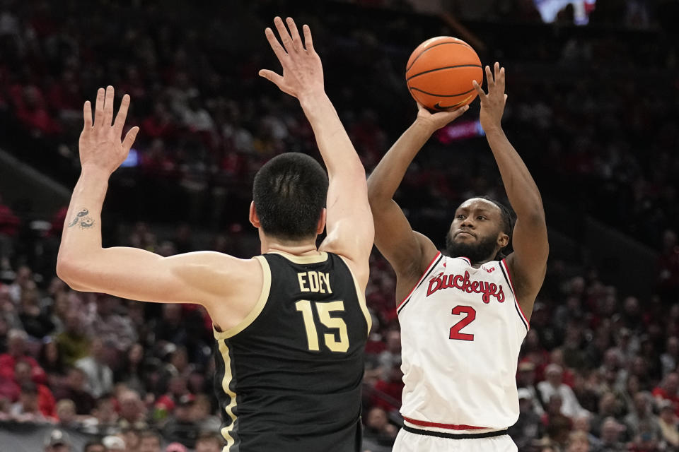 Ohio State guard Bruce Thornton (2) shoots in front of Purdue center Zach Edey (15) in the second half of an NCAA college basketball game, Sunday, Feb. 18, 2024, in Columbus, Ohio. (AP Photo/Sue Ogrocki)