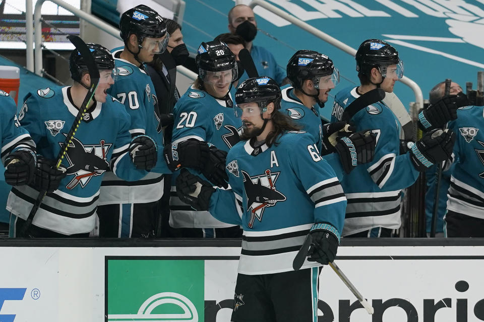 San Jose Sharks defenseman Erik Karlsson, foreground, celebrates with teammates after scoring a goal against the Colorado Avalanche during the third period of an NHL hockey game in San Jose, Calif., Monday, March 1, 2021. (AP Photo/Jeff Chiu)
