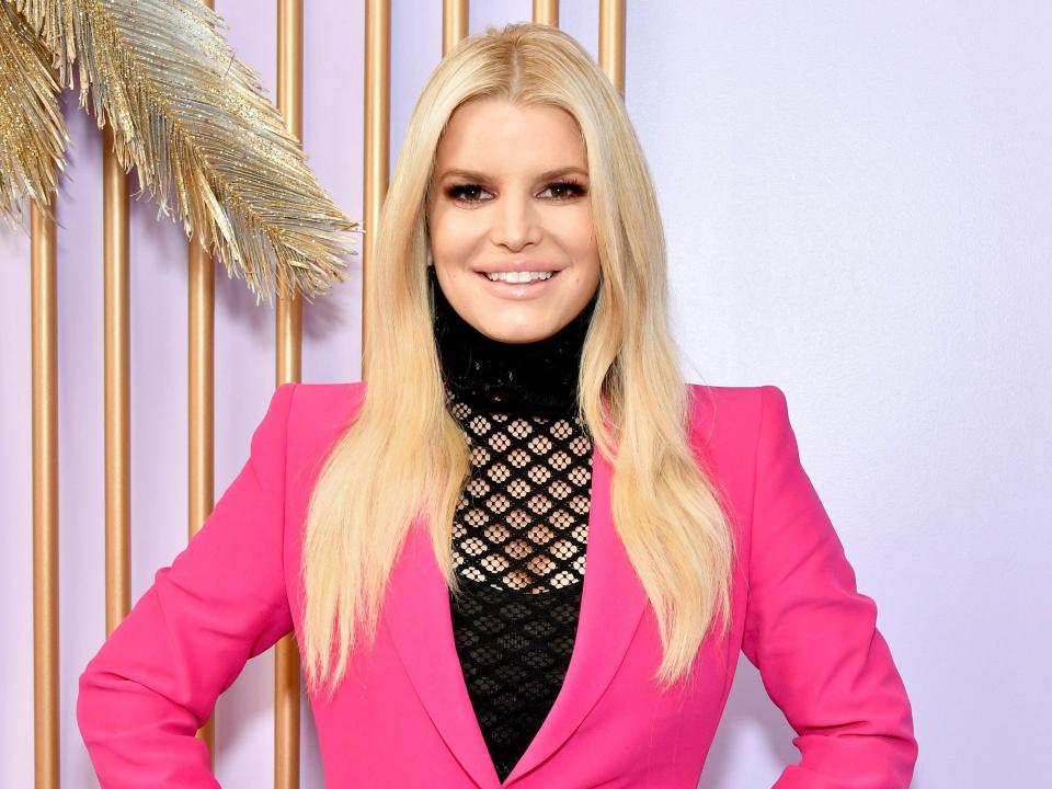 Jessica Simpson wearing a pink suit.
