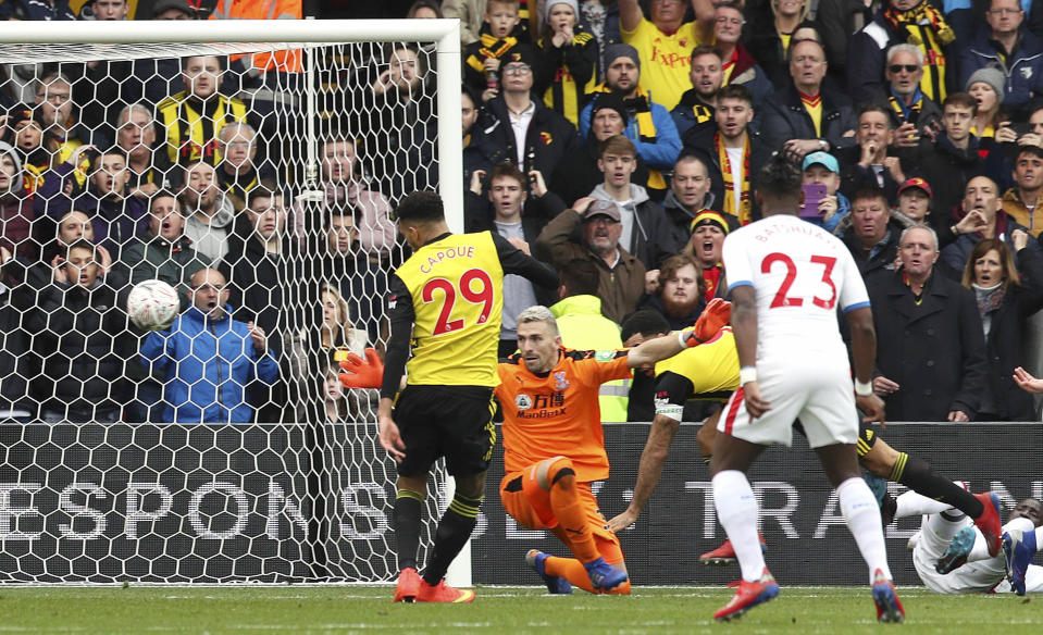 Watford's Etienne Capoue scores his side's first goal of the game during the FA Cup quarter final soccer match between Watford and Crystal Palace , at Vicarage Road, in Watford, England, Saturday March 16, 2019. (Jonathan Brady/PA via AP)