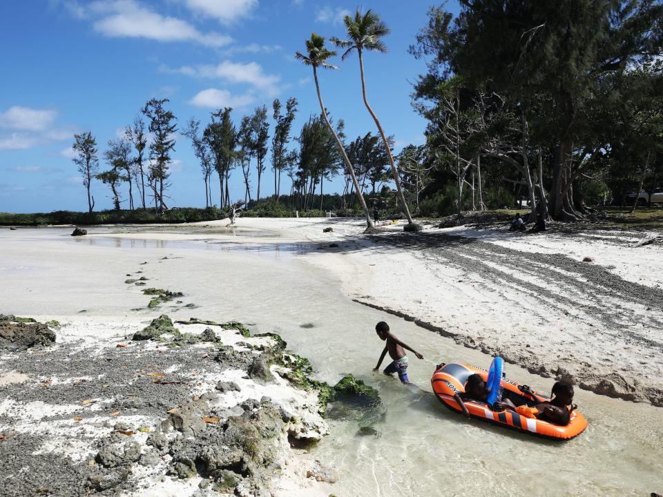 Kids play at Eton Beach on November 30, 2019 in Efate, Vanuatu.