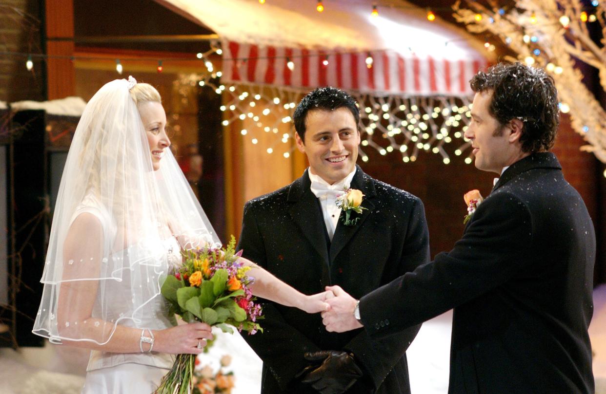 Phoebe (Lisa Kudrow) weds Mike (Paul Rudd) while Joey (Matt LeBlanc) officiates in a Season 10 episode of 'Friends' (Photo: Warner Bros. / Courtesy: Everett Collection)