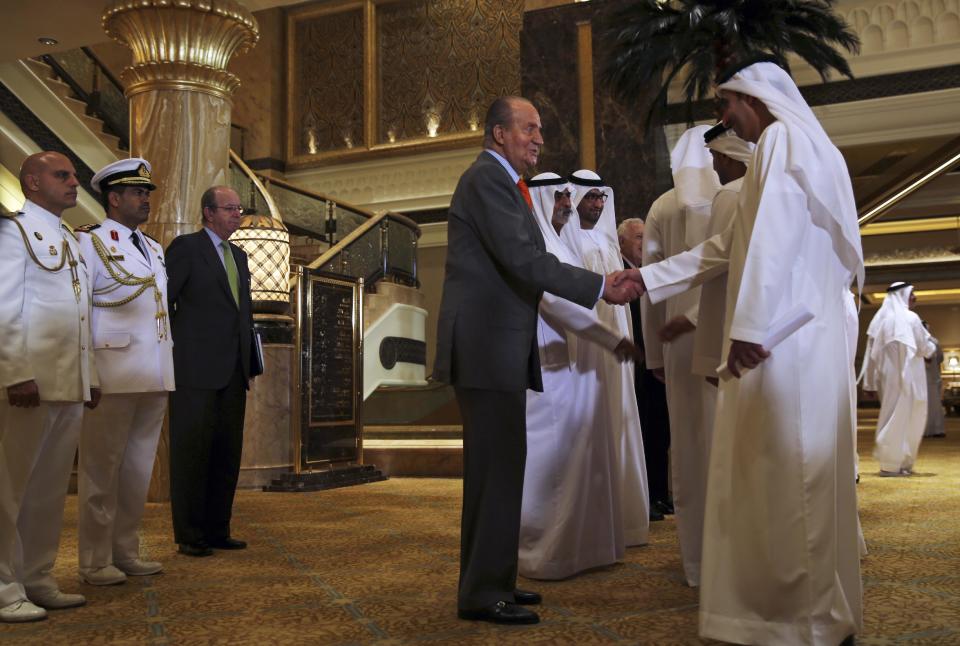 Spain's King Juan Carlos, center, shakes hands with the Emirati delegation at the UAE - Spain Economic Forum at the Emirates Palace, in Abu Dhabi, United Arab Emirates, Monday, April 14, 2014. King Juan Carlos of Spain has begun a visit to the United Arab Emirates by telling the oil-rich nation it is at the top of his country’s political and economic agenda. (AP Photo/Kamran Jebreili)