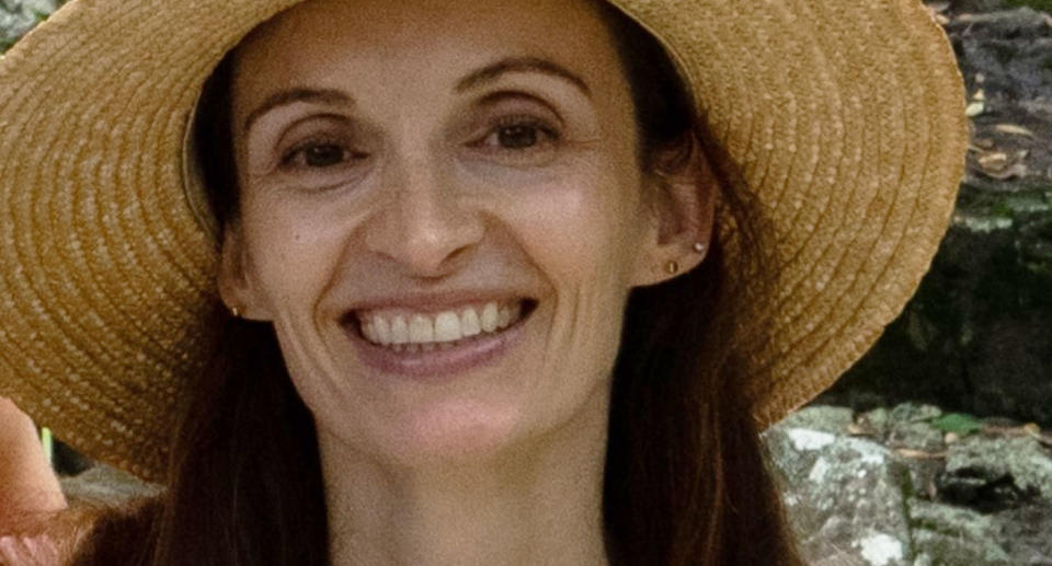 Afterpay user Melanie smiling in a large straw hat.