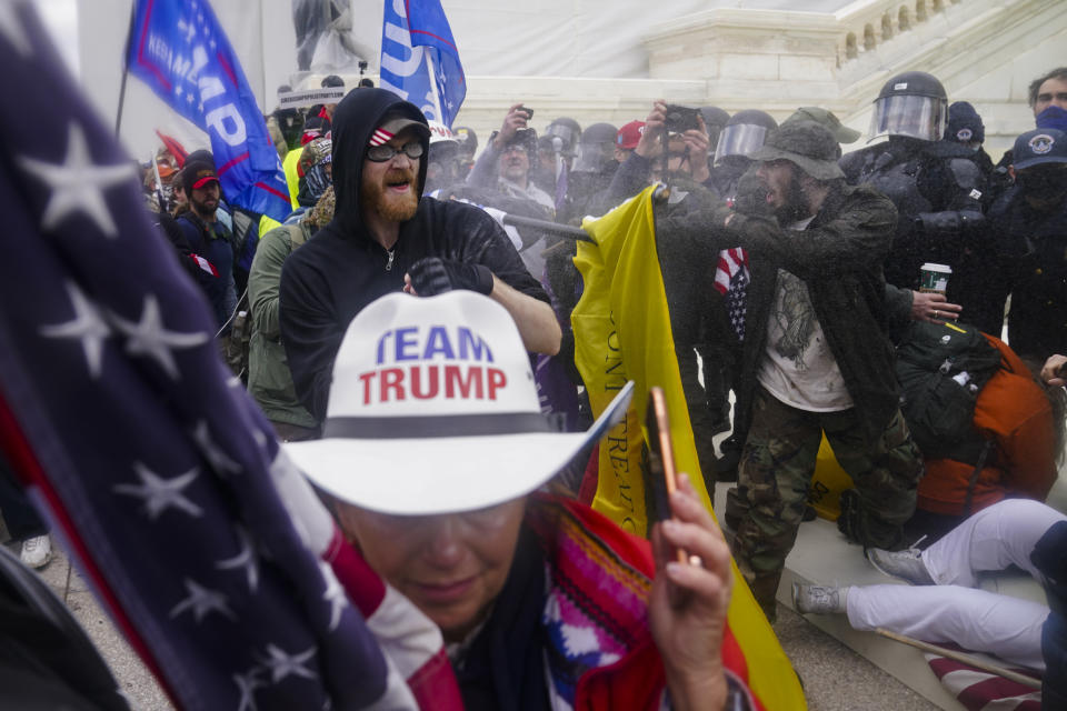 FILE - In this Jan. 6, 2021, file photo violent insurrectionists loyal to President Donald Trump try to break through a police barrier at the Capitol in Washington. Many of those who stormed the Capitol on Jan. 6 cited falsehoods about the election, and now some of them are hoping their gullibility helps them in court. Attorneys for several defendants facing charges connected to the deadly insurrection say they will raise their client's belief in conspiracy theories and misinformation, either as an explanation for why they did what they did, or as an attempt to create a little sympathy. (AP Photo/John Minchillo, File)