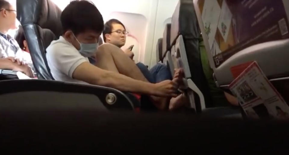 Air Asia passenger picks feet on flight