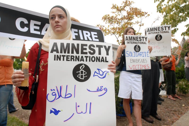 Mariam Howe joins Amnesty International demonstrators calling for an end to violence in northern Israel and southern Lebanon during a vigil near the State Department in Washington on August 7, 2006. On May 28, 1961, lawyer Peter Berenson published an article about political prisoners, forming the basis for what would become Amnesty International. File Photo by Roger L. Wollenberg/UPI