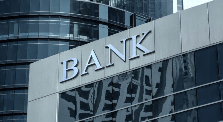 Image of a grey cityscape with a large corporate building that features the word bank on it