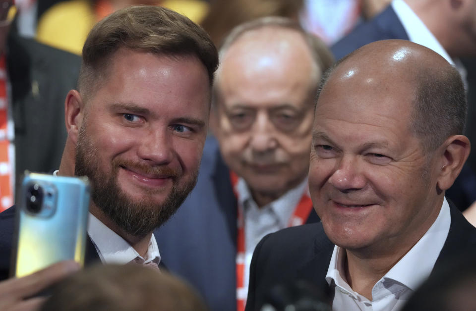 An unidetified person takes a selfie with German Chancellor Olaf Scholz, right, during a congress of the Party of European Socialists (PES) in Berlin, Germany, Saturday, Oct. 15, 2022. (AP Photo/Michael Sohn)