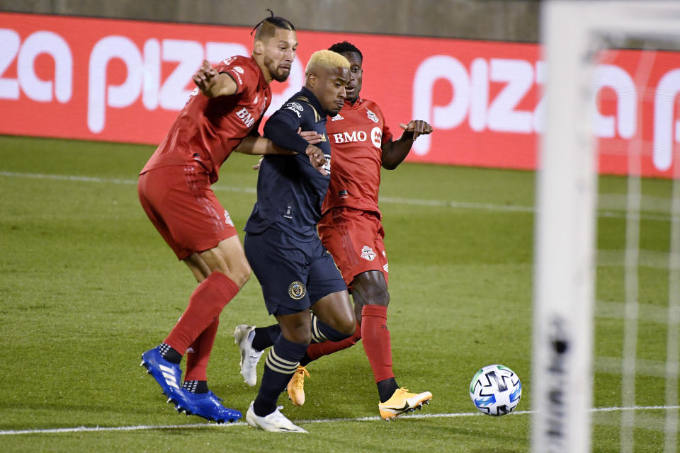 Philadelphia Union's Sergio Santos, center, cuts between Toronto FC's Omar Gonzalez, left, and Richie Laryea to score a goal during the first half of an MLS soccer match Saturday, Oct. 3, 2020, in East Hartford, Conn. (AP Photo/Jessica Hill)