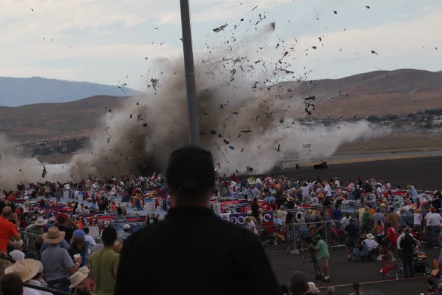 A P-51 Mustang airplane crashes into the edge of the grandstands during the airshow in 2011, killing 11 people. (Photo: Ward Howes via AP)