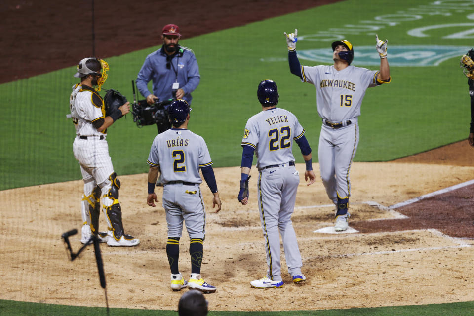 Milwaukee Brewers' Tyrone Taylor celebrates after hitting a three-run home run that scored Christian Yelich (22) and Luis Urias (2) against the San Diego Padres during the sixth inning of a baseball game Tuesday, May 24, 2022, in San Diego. (AP Photo/Mike McGinnis)