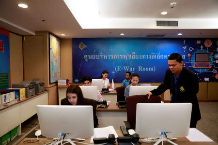 Government staff work as they monitor social media in a social media war room in Bangkok, Thailand March 8, 2019. Picture taken March 8, 2019. REUTERS/Soe Zeya Tun