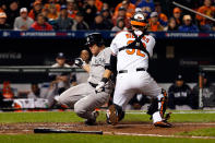 Russell Martin #55 of the New York Yankees is tagged out at home trying to score against Matt Wieters #32 of the Baltimore Orioles in the top of the seventh inning during Game One of the American League Division Series at Oriole Park at Camden Yards on October 7, 2012 in Baltimore, Maryland. (Photo by Rob Carr/Getty Images)