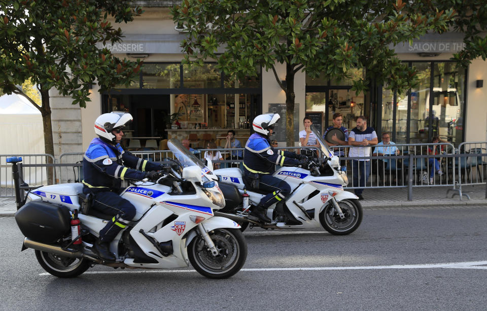 Police officers on motorcycles patrol past a cafe ahead of the G-7 summit in Biarritz, France Friday, Aug. 23, 2019. U.S. President Donald Trump will join host French President Emmanuel Macron and the leaders of Britain, Germany, Japan, Canada and Italy for the annual G-7 summit in the elegant resort town of Biarritz. (AP Photo/Peter Dejong)