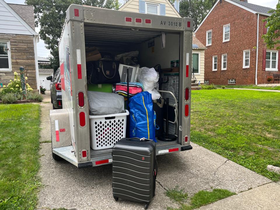 An open UHaul with boxes and bags inside.