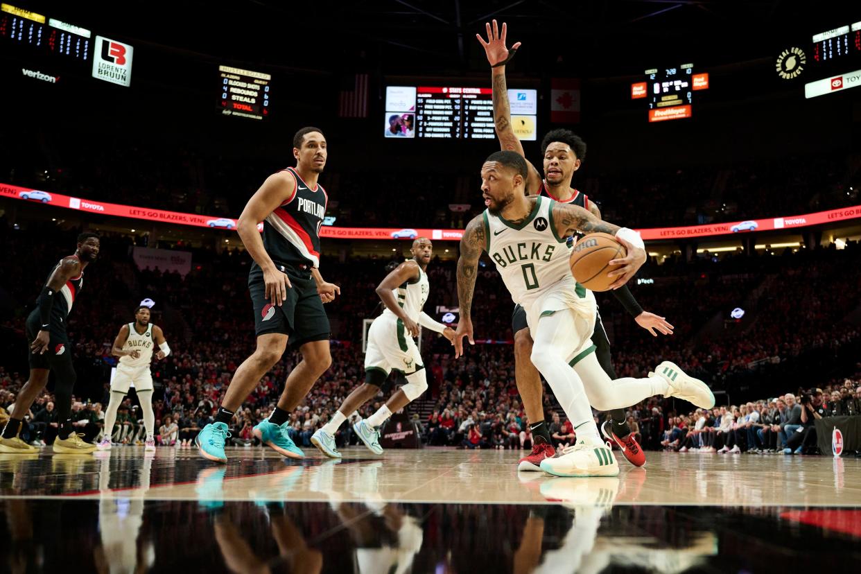 Jan 31, 2024; Portland, Oregon, USA; Milwaukee Bucks guard Damian Lillard (0) drives to the basket during the first half against Portland Trail Blazers guard Anfernee Simons (1) at Moda Center. Mandatory Credit: Troy Wayrynen-USA TODAY Sports