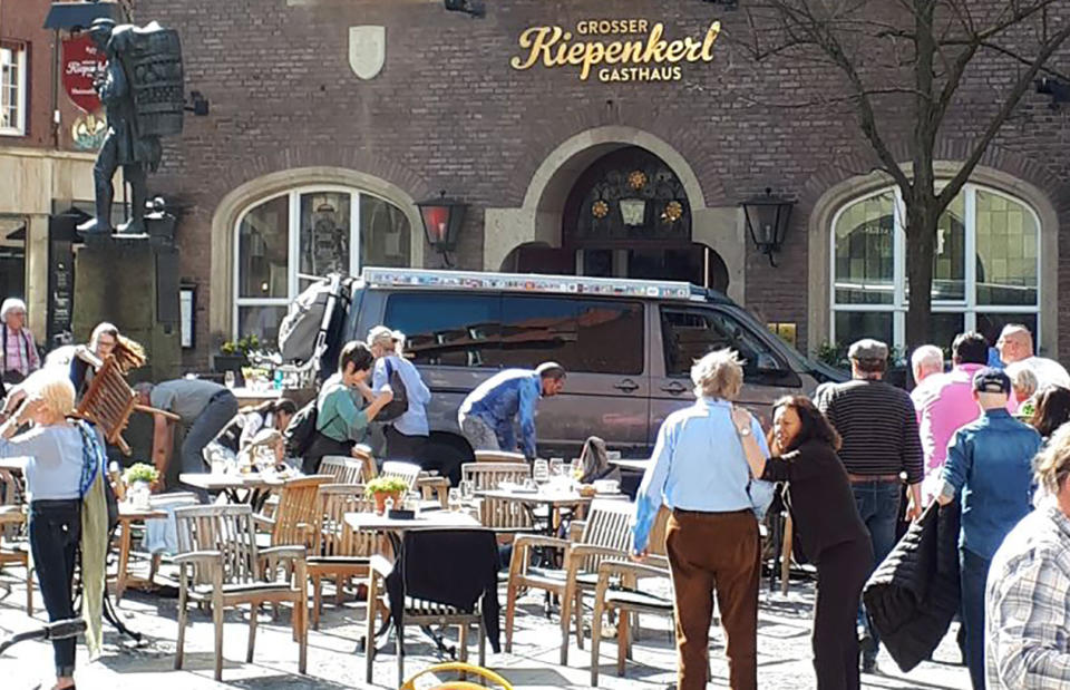 <p>People stay in front of the Grosser Kiepenkerl restaurant in Muenster, Germany, Saturday, April 7, 2018 after a vehicle crashed into a crowd. (Photo: Stephan R./dpa via AP) </p>