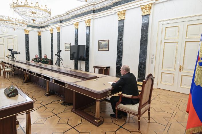 Russian President Vladimir Putin, right, speaks to Russian Defense Minister Sergei Shoigu, second left, and Head of the General Staff of the Armed Forces of Russia and First Deputy Defense Minister Valery Gerasimov, left, during their meeting in Moscow, Russia, Sunday, Feb. 27, 2022. (Alexei Nikolsky, Sputnik, Kremlin Pool Photo via AP)