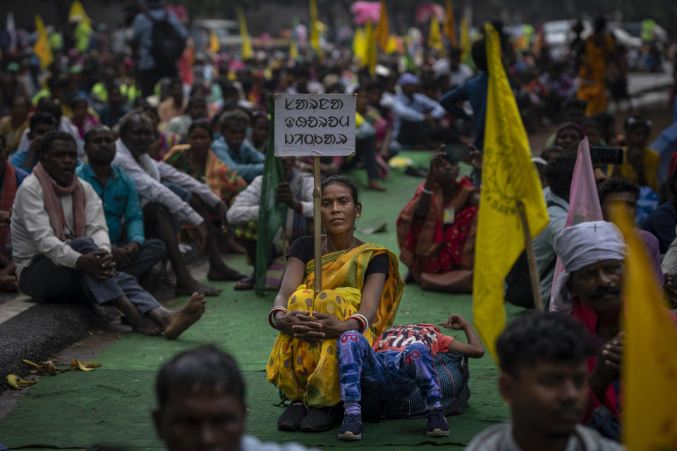 A tribes woman holds a placard which reads, "Victory to Sarna Dharma" as she participates in a sit-in demonstration rally to demand of recognizing Sarna Dharma as a religion in Ranchi, capital of the eastern Indian state of Jharkhand, Oct. 18, 2022. Tribal groups have held protests in support of giving Sarna Dharma official religion status in the run-up to the upcoming national census, which has citizens state their religious affiliation. (AP Photo/Altaf Qadri)