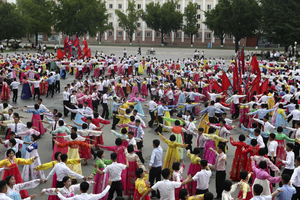 Youth and students hold dancing party for celebrating the 62nd anniversary of their late leader Kim Jong Il's first field guidance for the revolutionary armed forces, at the plaza of the Pyongyang Indoor Stadium in Pyongyang, North Korea Thursday, Aug. 25, 2022. (AP Photo/Jon Chol Jin)