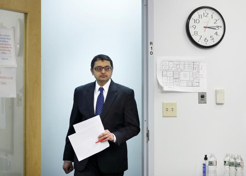 Dr. Nirav Shah, director of the Maine Center for Disease Control and Prevention, arrives at a news conference, Tuesday, April 28, 2020, in Augusta, Maine.(AP Photo/Robert F. Bukaty)