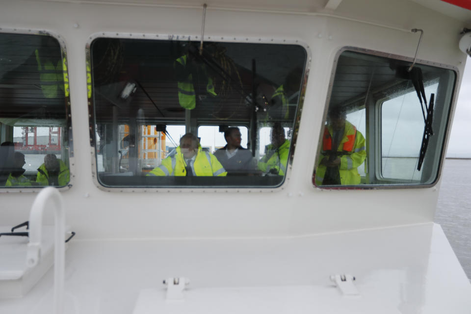 Britain's Prime Minister Boris Johnson steers a tug boat during a General Election campaign stop in the port of Bristol, England, Thursday, Nov. 14, 2019. Britain goes to the polls on Dec. 12. (AP Photo/Frank Augstein, Pool)