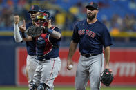 Boston Red Sox plyers, from left, third baseman Rafael Devers, catcher Christian Vazquez, and relief pitcher Brandon Workman react after Workman was called for a balk against the Tampa Bay Rays during the third inning of a baseball game Wednesday, June 23, 2021, in St. Petersburg, Fla. (AP Photo/Chris O'Meara)