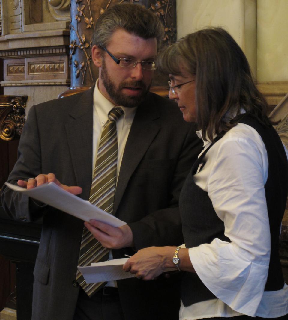 Landon Fulmer, left, policy director for Kansas Gov. Sam Brownback, consults with state Sen. Susan Wagle, right, a Wichita Republican, during a debate over tax cuts, Tuesday, March 20, 2012, at the Statehouse in Topeka, Kan. Wagle supports GOP Gov. Sam Brownback's plan to reduce income taxes as a way to stimulate economic growth. (AP Photo/John Hanna)