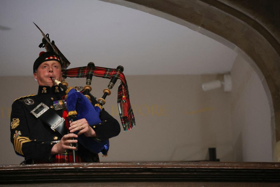 A piper from the Royal Regiment of Scotland plays on the day of the state funeral and burial of Britain's Queen Elizabeth, at Westminster Abbey in London on September 19, 2022. (Photo by PHIL NOBLE / POOL / AFP) (Photo by PHIL NOBLE/POOL/AFP via Getty Images)