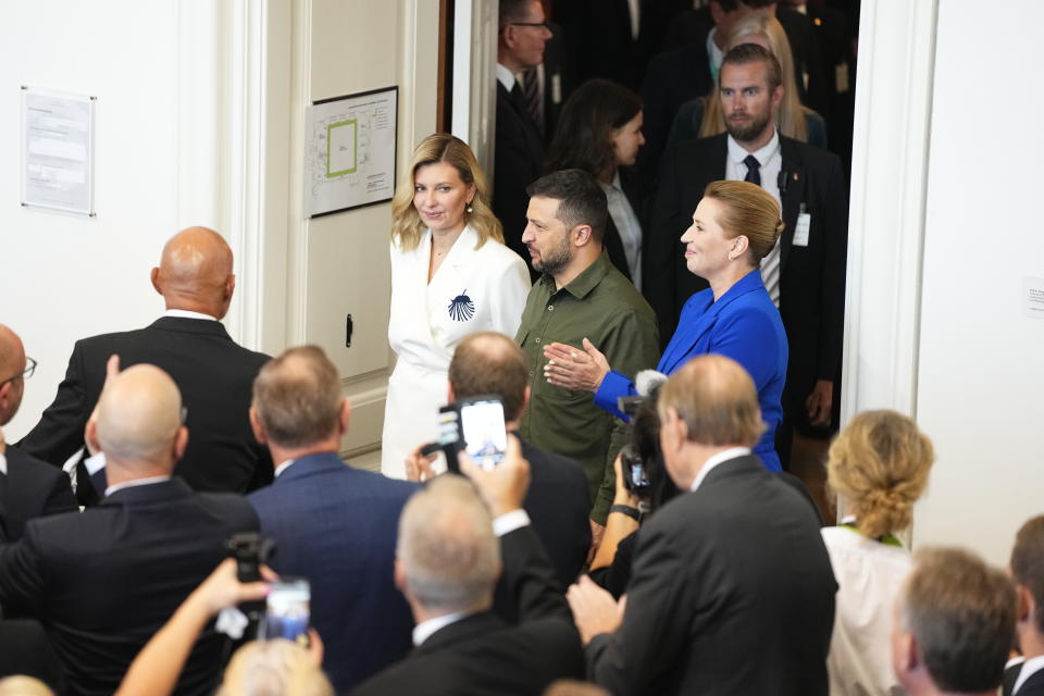 Ukraine's President Volodymyr Zelenskyy and Ukraine's First Lady Olena Zelenska, left, are greeted by Danish Prime Minister Mette Frederiksen and Danish Members of Parliament as they arrive at the Danish Parliament in Copenhagen, Monday Aug. 21, 2023. (Mads Claus Rasmussen/Ritzau Scanpix via AP)