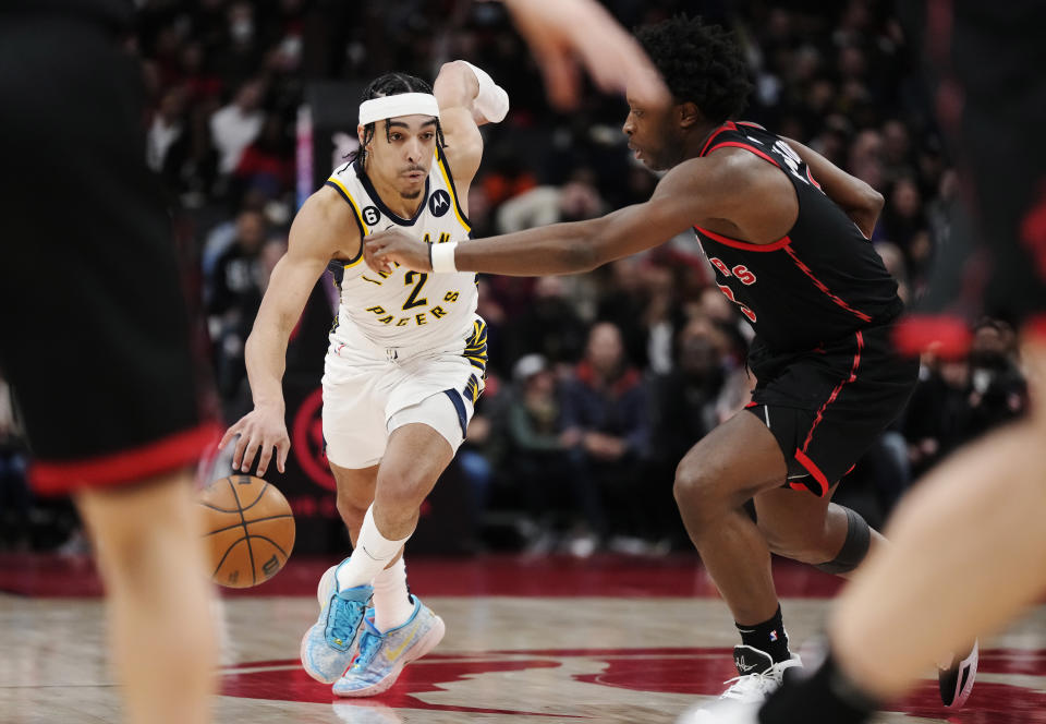Indiana Pacers guard Andrew Nembhard (2) drives past Toronto Raptors forward O.G. Anunoby (3) during the second half of an NBA basketball game in Toronto, Wednesday, March 22, 2023. (Frank Gunn/The Canadian Press via AP)