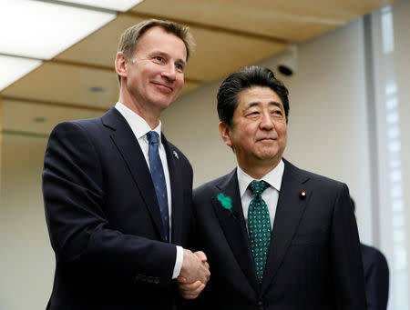 Jeremy Hunt, British Secretary of State for Foreign and Commonwealth Affairs, shakes with Japanese Prime Minister Shinzo Abe (R) during a courtesy call at the latter's official residence in Tokyo, Japan, April 15, 2019. Kimimasa Mayama/Pool via REUTERS
