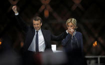 French President elect Emmanuel Macron and his wife Brigitte Trogneux celebrate on the stage at his victory rally near the Louvre in Paris, France May 7, 2017. REUTERS/Christian Hartmann